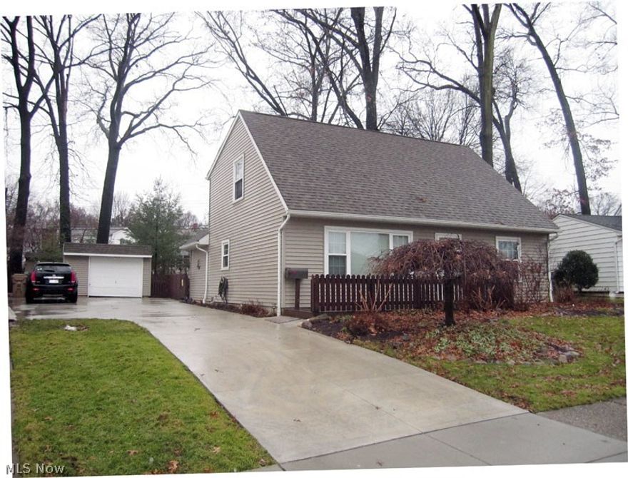 This is virtually a new home.  Completely rebuilt in 2002.  Features 1st floor master and two gorgeous bedrooms on 2nd floor with full bath.  Second floor bedrooms have vaulted ceilings and both baths are beautiful.  Huge kitchen includes all appliances.  Absolutely breathtaking back yard has a park like setting and is completely fenced.  There is a covered bar which is great for seasonal entertaining.  This is a must see home.  Enjoy Cuyahoga Falls utilities & amenities.  Close to schools and major shopping.  Close to Golf Course and City Parks.  Concrete drive in 2015, stamped concrete walk in back yard 6 x 12 2014, kitchen and bath counters in 2014.  All kitchen & bathroom plumbing fixtures new in 2014 (Moen), hardwired surround sound in living room, cable/internet access in enclosed bar area.  Covered grilling station.