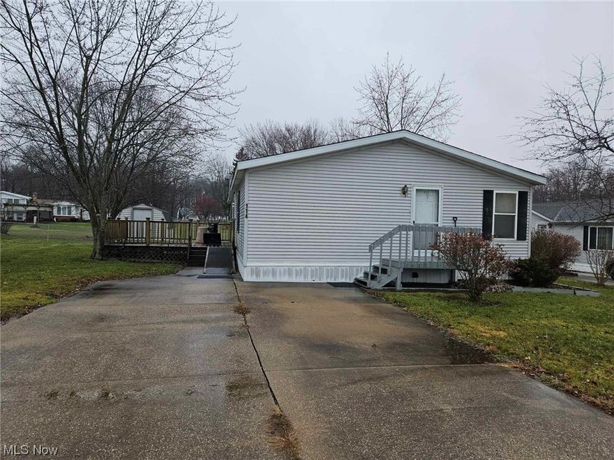 Welcome to this move-in ready trailer located in James A Garfield school district. All the big ticket items have been updated on this home in the last two years: roof, furnace, central air, and hot water tank. New carpet throughout. The large master suite has a walk in closet and private bathroom with skylight, garden tub and walk-in shower. Laundry room has extra storage. Kitchen has a great layout with a space to eat-in, a breakfast bar, and a dining area overlooking the living room. Large custom deck for relaxing and enjoying the expansive backyard. 2X6 insulated walls to cut down on heating and A/C bills. Schedule to see this cost effective home today!