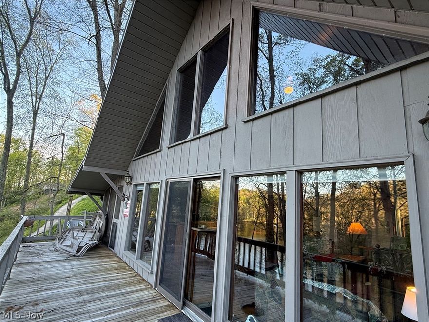 This LAKEFRONT home on TWO LOTS being sold Turkey AT UNDER $600,000 is quite an opportunity for an astute buyer.  This rustic home with the metal roof new in the fall of 2025features two bedrooms and two baths on the main floor, possibly a very large sleeping loft above that our looks the great room and kitchen. Master bedroom has a private bath. The kitchen has a breakfast bar plus a kitchen table area. There’s lots and lots of WINDOWS AND SLIDERS on the EAST-FACING LAKESIDE OF THE HOME.  This home is being sold, turn key, including everything even the John Deere gator and the pontoon boat. There are steps to from the house to the lake as well as a cement drive down to the lake for easy and comfort access to the lakefront where you’ll find a full dock with a boathouse. This home is located such that the boathouse is in an awake area. . This home is located such that the boathouse is in a No Wake area so swimming and fishing is certainly more comfortable and safer.  There is a 8 x 33’ deck off of the great room. Add the cement patio down below on the basement level. There also is a quiet inviting 19x 9 screened porch on the side of the home set among tall trees, and pine trees with beautiful views of the lake and this wonderful natural setting. The kitchen, great room and loft have very tall vaulted ceilings that are adorned with beautiful rustic wood planks. N