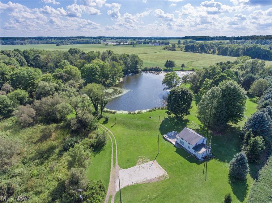 Don't miss out on this awesome opportunity to own this breathtaking property. This is the perfect property to build your DREAM HOME.  Current 1488 sq. ft. home can then be used as a workshop.  This secluded beautiful property features over 13 acres of land with a spacious picnic pavilion that holds 12 tables.  A gorgeous almost 3 acre POND fully stocked is surrounded by woods. Enjoy entertaining as you soar across using the professional zipline.  Tour the views from the pond on the canoe, paddle boat or aluminum boat. If you're looking for a property with easy access to several major highways, you must see this one of a kind relaxing retreat that won't last long.  Enjoy country living to the fullest. Bring your 4-wheelers, fishing poles, ice skates and livestock.  This is the perfect place for hosting multi-family gatherings, reunions, weddings, picnics, fishing derbies and much more. The property is in Marlington School District.  It has still retained its original charm with saw-cut