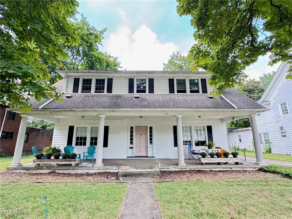 This nearly 100 year old home retains the charm of the 1920's. Large front & back yard and wide comfortable front porch. Center hall Colonial with large entry foyer and open spindled staircase. Off to the right is the massive living room with fireplace centered on the north wall. The dining room is off to the left and then through the breakfast room with floor to ceiling cabinets joins the kitchen. There's a handy half bath by the rear entry and kitchen with new vanity, mirror and light. Upstairs the staircase is still open in the foyer with four nearly identical sized large bedrooms radiating off this hallway. Throughout the entire house are beautiful restored hardwood floors. The rear bedroom has door to balcony overlooking large back yard. The upstairs offers newer Pella windows. Lots of wallpaper has been removed and walls painted neutral colors. All bedrooms have new ceiling fans. The third floor can be used for a variety of uses. The house has a newer boiler and updated electric breaker box. Glass block windows with vents. Chimney has been repaired and screened.