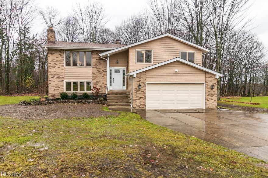 Immaculate, fully remodeled 3 bed, 3 bath home set back on 2 acres in the highly sought after city of Kirtland!! Seller has left nothing to do, just unpack and move right in! Main floor offers open layout living room and dining area with vault ceiling, brand new kitchen (all appliances stay), master suite with brand new full bathroom and tons of closet space.  Two additional bedrooms, another full updated hall bathroom and linen closet round out the main floor. Lower level features large family room with fireplace and slider to back patio, full updated bathroom, huge laundry/utility room and two car attached garage. Updates include: all new LVT flooring throughout, fresh paint, new doors, brand new kitchen and bathrooms, all new fixtures, trees removed and trimmed, new landscaping, new '23 hot water tank, new '23 AC, 2015 furnace, new '23 plastic distribution boxes for septic system, 2015 siding/roof/gutters. This one will go fast, don't miss your chance!!!