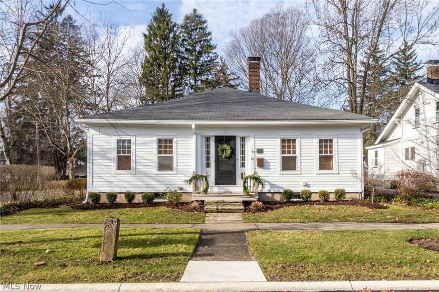 Incredible opportunity to live in the heart of Chagrin Falls! This charming three bedroom / two bath ranch offers open spaces, light filled rooms and fantastic updates. The entry opens into a wide hallway with wood burning fireplace, stone surround, and beautiful hardwood floors throughout. The open concept family room with updated fixtures leads into additional living or dining space with original built-ins and large floor-to-ceiling bay windows. Spacious kitchen includes butcher block island, stainless steel appliances, granite countertops, and eat-in breakfast nook. The owner’s suite features original wood burning fireplace and en-suite bath with updated lighting and cabinetry. The two additional bedrooms share the adjoined full bath and dressing room with closet space vanity. First floor laundry makes for easy access. The side patio, green space and deck offer the perfect outdoor space for entertaining. Two car garage. Just steps away from shops, restaurants and the Falls. The quin