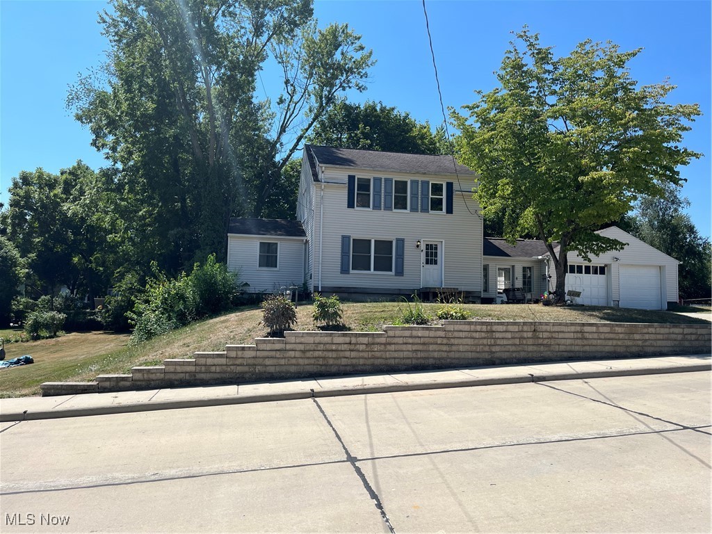 Wonderful colonial in the heart of Mogadore. Home is ready for your imagination to make it your dream home. It features a 2 car garage which has a breezeway between the garage and home. Enter into the L shaped kitchen which includes a refrigerator and stove. Walk into the dining room with hardwood floors which has the door to a screened in porch. The first floor also features a first floor bedroom & bath. The spacious living room with hardwood floors leads you to the stairway that takes you upstairs to an additional 3 bedrooms & bath. The possibilities are endless. The home sits on 2 1/2 beautiful treed parcels. Walk to park, library or schools. There is much cosmetic work that needs done but a rare opportunity. Selling "As Is". Quick possession.