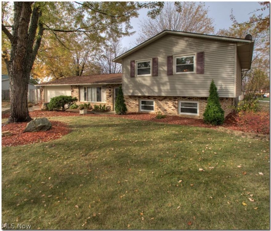 With plenty of space for entertaining and comfortable everyday living, this roomy west side split has much to offer.  Greet guests in the living room and serve dinner in a dining area that can be formal or informal.  The kitchen has newer flooring and kitchen appliances stay. The family room on the lower level features an attractive angled woodturning fireplace for cozy cool weather gatherings.  Three bedrooms and a beautifully remodeled full bath are on the upper level while another full bath , storage room, and large laundry area complete the lower level. Newer windows and central air help to bring about year round comfort.  The attached two car garage offers additional storage above.  Outside is a patio with extended deck in a privacy fenced yard, tastefully landscaped and shaded by tall trees, perfect for children or pets or just private relaxation.  A home warranty offers peace of mind.