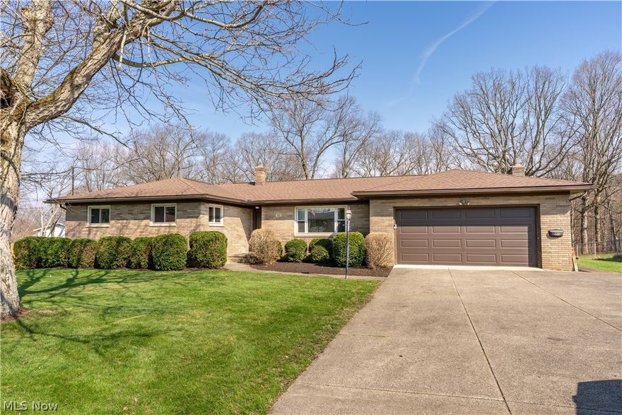 Welcome to your private retreat near the heart of Portage Lakes in Akron! Situated on 1.27 acres, this attractive ranch offers peaceful, nature-filled living with everyday convenience. Inside, an inviting entrance leads to 3 spacious bedrooms, 2 full baths, a large living room, and a cozy family room with a gas fireplace. The expansive eat-in kitchen features abundant cabinetry, ample counter space, and casual dining, with a deck overlooking the wooded backyard—perfect for relaxing or entertaining. Enjoy a thoughtful layout with plentiful closet space throughout. The unfinished walkout basement offers incredible potential, complete with a workshop, laundry area, and extensive storage. Outdoors, a wooded backdrop and scenic stream create a private, park-like setting. Located in the desirable Portage Lakes area, this neighborhood offers a relaxed, lake-town feel with friendly neighbors. Enjoy nearby boating, fishing, and seasonal beauty, all while being minutes from shopping, dining, and the conveniences of Akron and Canton. This home offers the perfect blend of comfort, privacy, and lifestyle—don’t miss it!