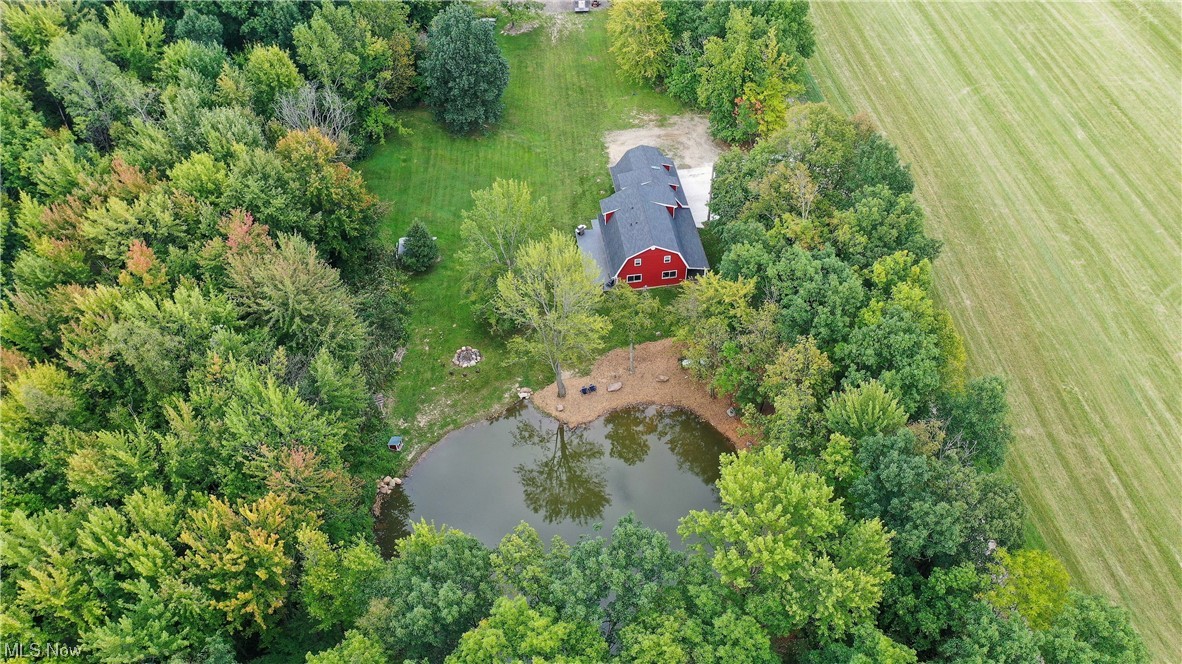 Totally rebuilt charming 4-bedroom 3-bathroom farmhouse with an additional suite above the 2-car garage located on over 5 beautiful acres! The iconic barn shaped county home was rebuilt from top to bottom with a large front porch and back deck that overlooks the stocked pond. Step inside the charming great room and see new LVT flooring throughout, new lighting and trim work. Notice the recently updated white kitchen with all new appliances and lots of cabinets space as well as a pantry. There is a first-floor laundry room and full bathroom as well as a first-floor bedroom or home office. Upstairs in the main home are three more bedrooms and two beautiful, updated bathrooms including a spacious master on suite.
Connected to the home and over the garage is a full apartment complete with full kitchen, full bathroom and bedroom that could be rented. The garage and apartment have their own heating and cooling systems. The property has a chicken coop, matching playhouse and raised b