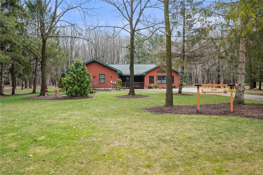 Nestled on a peaceful wooded property, this beautifully maintained log home offers the perfect blend of rustic charm and modern comfort. Surrounded by mature trees and open green space, the property provides a private retreat while still offering convenient living space and exceptional functionality. Inside, you’ll find warm natural wood finishes, vaulted ceilings, and an open-concept layout that creates an inviting atmosphere throughout the home. The spacious living area flows seamlessly into the kitchen and dining spaces, making it ideal for everyday living and entertaining. The kitchen features granite countertops, stainless steel appliances, a large island with seating, and a unique copper farmhouse sink. An additional living space was thoughtfully added to the home, featuring a cozy fireplace that creates the perfect setting for relaxing or gathering with family and friends while enjoying the surrounding views. The primary bedroom offers a relaxing retreat with vaulted ceilings, wood accents. Additional bedrooms offer comfortable space for family or guests. A standout feature of the property is the impressive detached outbuilding, offering abundant space for a workshop, equipment storage, hobbies, or recreational use. The large open interior provides excellent flexibility for a variety of uses. Enjoy the peaceful outdoor setting with open yard space, wooded surroundings, and plenty of room to relax or entertain. This unique property offers the perfect combination of privacy, character, and functional space both inside and out.