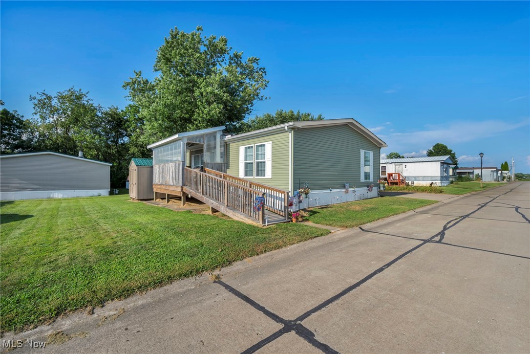 Welcome to 110 NW Lebanon Rd in the desirable Lincoln Terrace Estate of Dalton, OH. A truly rare offering of style, space, and accessibility in a 2023-built manufactured home. This spacious 3-bedroom, 2-bathroom home spans 1,330 sq ft and is far from your average double wide. It was thoughtfully designed with accessibility in mind, featuring 36-inch doors throughout, an open floor plan, and a custom-built ramp leading to an enclosed front deck.
Inside, you'll find an inviting living room with eye-catching ashtray ceilings and modern beams, and a family room with beamed ceilings and custom built-ins. Recessed lighting adds a warm ambiance throughout the home. The kitchen is a chef’s dream with sleek white cabinetry, lots of counter space, a large island, and stainless steel appliances, perfect for entertaining or quiet nights in.
The luxurious primary suite offers a spa-like bathroom with a tiled walk-in shower, dual vanities, and an expansive walk-in closet. Step outside to enjoy multiple decks, one enclosed for year-round comfort, and beautifully maintained outdoor space.
This move-in ready home offers easy, affordable living without compromising style or convenience. Located near local amenities and within a peaceful, well-maintained community, this property is a must-see for anyone looking for an accessible home that breaks the mold of traditional manufactured living.