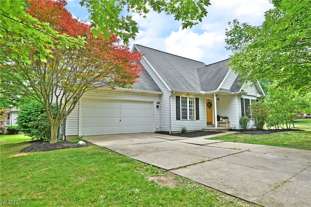 Delight in the two floors of casually charming living space with this delightful Ravenna home! Nestled beneath the colorful trees of a prominent corner lot set deep within a desirable local development, this residence showcases its perfectly cultured living space, packed with tasteful updates and plenty of style. The bold, amber entry door opens to reveal an inviting living room as the carpeted staircase rises to meet the picket lined loft overhead. Hardwood styled flooring is awash in the midday sun thanks to tall windows that illuminate the open design. Nearby a must-see kitchen awaits with its granite topped island and matching countertops that pair perfectly with the dark stainless appliances. A bevy of recessed lighting shines down from above to pair with the decorative hanging light centered over the dining area. Meanwhile, kick back in the illustrious finished sunroom as you take in the backyard views. First floor laundry is located next to a daring full bath, offsetting the eng