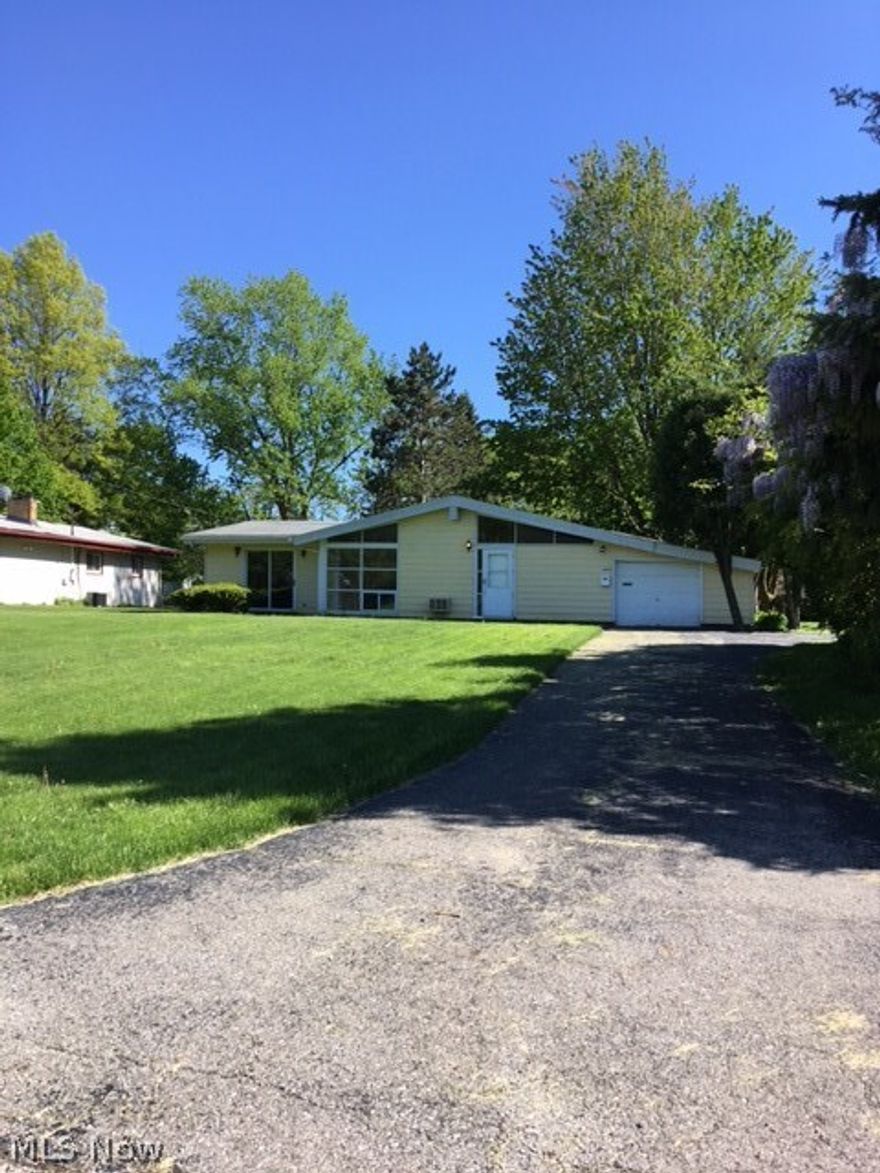 Now back on the market.  Freshly painted inside with newly installed carpeting, this California ranch is truly representative of today's open floor plan.   Home is on a quiet cul-de-sac street and has everything you need on one floor.   Galley style kitchen is useful for easy food prep.   In addition to the great room, there are two extra room plus, of course, the three bedrooms.
Covered patio overlooks park-like yard on this over 1700 s.f. home.