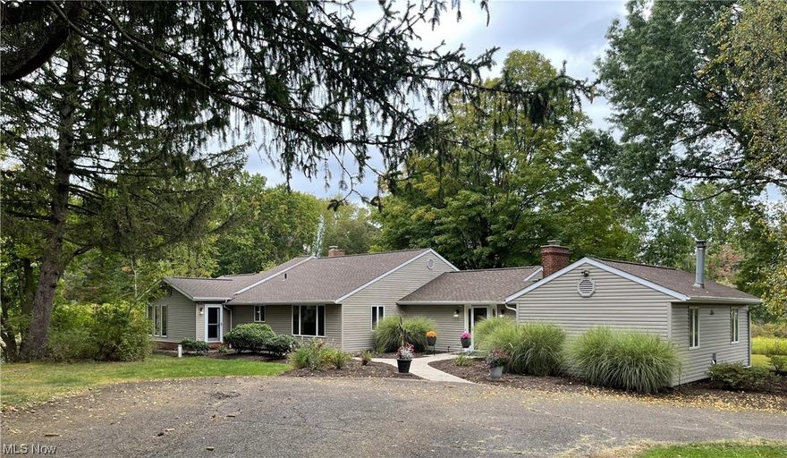 Private 3 BR, 2.5 BA ranch secluded on a 10.5 ac lot with 2 ponds, trees and convenient to Stark Parks Trails.  Enjoy this one and only property all 4 seasons of the year.  Split floor plan with first floor laundry, nice sized master suite with large walk in closet, bath with jetted tub, tiled, walk-in shower and dual vanities.  2 additional bedrooms, large living room with wood burning fireplace, kitchen open to dining room and family room that overlooks one of the ponds. Finished game room in lower level and 2 outbuildings that can accommodate up to 5 cars. Both out buildings have newly run electricity, roofs and door openers.  New roof on house 2023, Zoned heating and cooling- new furnace in 2022, hot water tank 2021, water tx system 2022, footer drains redone 2020.  If you are looking for privacy surrounded by nature yet convenient, this home is for you!