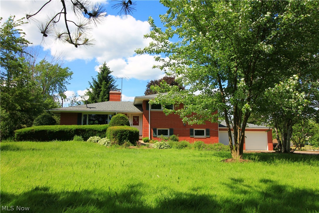 Amazing Brick Split Level- Well Maintained and updated throughout. New carpet, paint and appliances. The kitchen and dining area features wood floors, granite counter-tops, and custom Hickory wood cabinets! The living room features a wood burner insert. Boasting triple pane windows throughout, newer roof, A/C, furnace, and much more! Large amounts of storage areas with over-sized closets & full basement. 4th Bedroom/Guest Suite/Office space w/additional full bath in lower level 3 season room off kitchen. Featuring closet organizers in all bedrooms. Basement boasts large gathering spaces, fireplace & extra room ready for finishing. Large private yard, professionally landscaped and ready for a new owner. Call today.