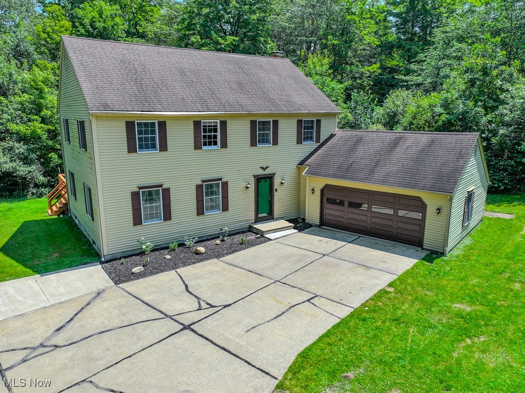 Tucked away on a picturesque cul-de-sac in Munson Township (Chardon Schools), this spacious 4-bedroom colonial offers privacy and serene wooded views. Inside, enjoy generously sized rooms throughout—including a large living room, formal dining room, and a flexible family room that opens to a massive deck, perfect for entertaining without disruption from neighbors. The eat-in kitchen provides ample cabinet space, while the oversized owner’s suite features three closets and a private en-suite with double vanities. Three additional bedrooms and two more full baths complete the second floor. The home also includes a full basement with laundry and mechanicals, plus an oversized 2-car garage with extra space for storage or equipment.