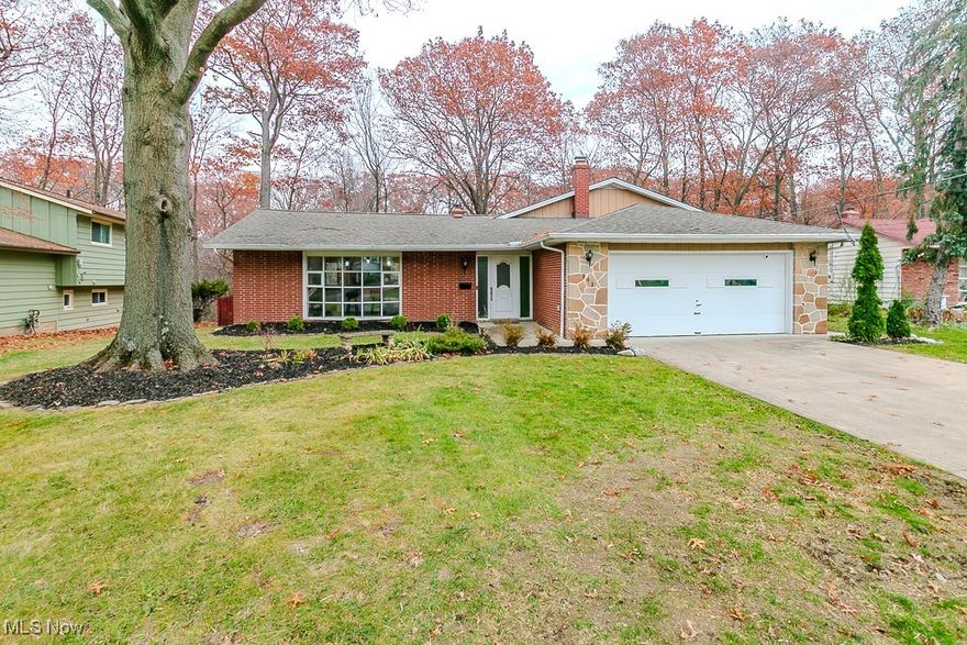 Step through the front door and into a bright, open floor plan featuring a vaulted ceiling that connects the kitchen and dining area. The updated kitchen offers granite countertops, ample cabinetry, a center island, and stainless steel appliances. Adjacent to the kitchen is the inviting great room, also with a vaulted ceiling, complete with a wood-burning fireplace to sit in front of on cold winter nights and a sliding door that leads to the deck with a hot tub. The second floor features three spacious bedrooms, including a primary suite with a walk-in closet and a remodeled bathroom showcasing granite countertop and a walk-in tile shower. The hallway bathroom has also been tastefully updated to include tile bath/shower and granite countertop cabinet. The lower level provides endless possibilities and includes a laundry room, half bath, and a dry bar with a granite countertop—ready to be finished to suit your needs. Sliding door offer easy access to the backyard. The fully fenced backyard is perfect for relaxation or entertaining, featuring a fire pit for cozy evenings and a scenic ravine with a creek. Additional highlights include a two-car attached garage located off the foyer for easy entry with pull down attic steps and plenty of cabinets for storage. Some updates include: Sections of the home is  wired for a whole-home generator 2024,  C/A 2025, Water Tank 2024.