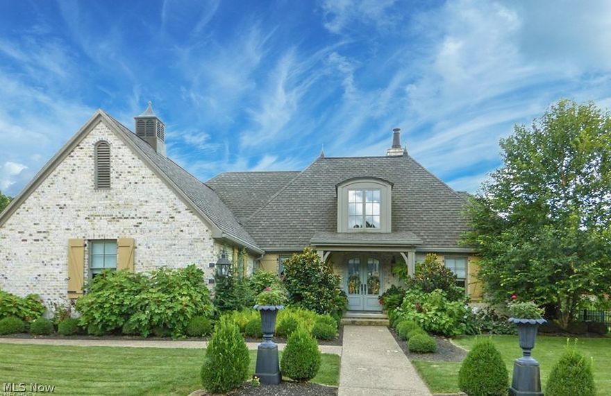 Custom one owner European style cottage. This John Tee plan features beautiful open living with symmetry, quaintness and the details of fine french architecture. You will appreciate all brick construction, oversized windows, complimented by real operable shutters, hardwood floors throughout, bench built cabinetry, eight foot interior doors and ten foot ceilings. Total one floor living with dual owners suite. Full finished lower level.  One third irrigated grounds, covered porches and raised terrace. The protection of a home warranty