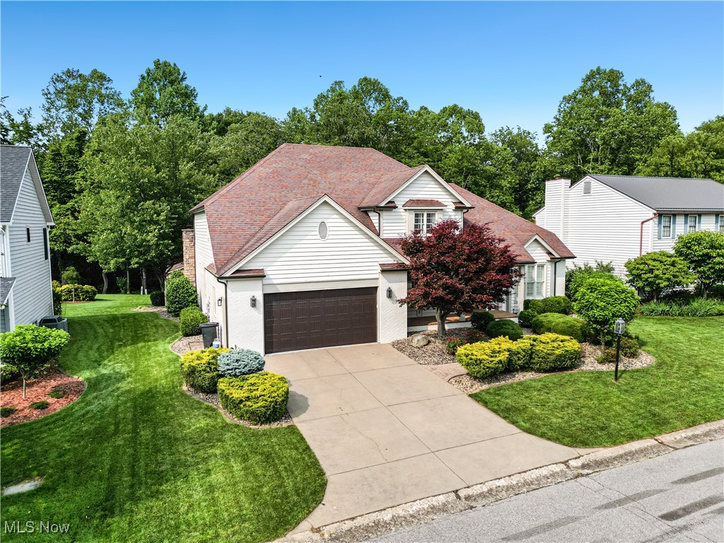 Welcome to this stunning custom-built home nestled on a quiet cul-de-sac in the highly desirable Greenmont Circle community. This beautifully maintained brick and cedar residence offers over 5,000 square feet of thoughtfully designed living space, blending timeless elegance with modern comfort. As you step inside the main living area you're welcomed by vaulted ceilings and a warm inviting atmosphere. Throughout the home, you'll find custom cabinetry, custom plantation shutters and quality finishes that speak to the craftsmanship and care poured into every detail. The heart of the home is the beautiful gourmet kitchen, complete with granite countertops, a large center island with prep sink, top-of-the-line appliances and abundant storage. This kitchen delivers both function and flair. The kitchen opens seamlessly into the spacious family room, featuring a wood-burning fireplace perfect for cozy evenings and holiday gatherings. This home offers five generous bedrooms and three and a half bathrooms, including a luxurious primary suite on the main floor. The primary suite offers an ensuite bath. Upstairs, you'll find additional bedrooms and ample storage throughout. Downstairs, the partially finished walk-out basement expands your living space with a 19'x19' recreation room, a 16'x14' bedroom, full bath-ideal for a guest suite, game room, or media area. You'll also find a spacious 400-sft unfinished storage area perfect for seasonal items or future expansion. Outside, enjoy the peaceful privacy of a professionally landscaped yard and outdoor living spaces ideal for relaxing or entertaining, plus you'll enjoy a sweet cottage with electric for that extra project or a little hide-away. This home offers space, style, and a setting you'll love coming home to. Close to parks, schools, and everyday conveniences! Homes like this in Greenmont Circle don't last long!