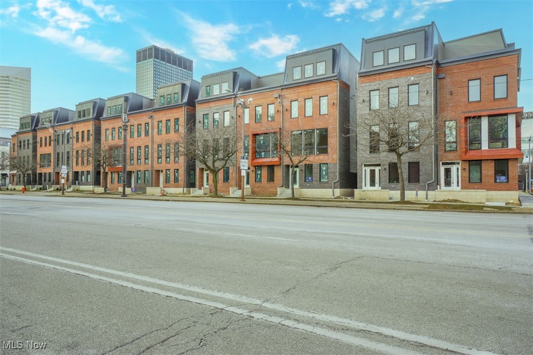 MOVE-IN READY! Eligible for Cleveland's 15-Year Tax Abatement! In the Heart of Downtown Cleveland!
Experience the bliss of a contemporary residence in the heart of Downtown Cleveland. Introducing the second phase of The Avenue Townhomes presented by Knez. Each residence at The Avenue exudes luxury with four floors of modern-designed living space and lavish features, promising an urban experience entirely reimagined. This spacious end unit townhome has 2497 square feet with an additional 265 square feet of rooftop deck and an attached two car, heated garage! Three true bedrooms give you the space you need including an en-suite bedroom suite on the first floor. 10’ ceilings on the 2nd floor and 9’ ceilings throughout the rest of the home make this townhome feel even bigger!
Elevate your quality of life with the finest finishes and materials. Find upgraded tile, luxury vinyl flooring or carpet on each level, complemented with quality quartz countertops throughout. Bring out your inner chef with a sprawling stone island, KitchenAid stainless steel vented chimney hood, microwave drawer & dishwasher and 42” soft-close upper cabinets that grant you all the space you need. This end unit has an electric fireplace and huge, stunning, Andersen black windows, 10' ceilings on the second floor, and 9' ceilings on all other floors to add to the already open and airy floorplan.
The primary bath has double sinks and an exquisite tiled shower with frameless, all glass door. Entertaining guests has never been easier with a 4th-floor entertainment room. Featuring a sleek wet bar, a half bath, and an attached roof-top deck, you can fully appreciate the ever-changing views of Downtown all from home. Find solace in knowing your home is not only eco-friendly with a 95% energy efficient York furnace, 13 seer York air conditioner and Rinnai tankless hot water tank, but also tailored to you!