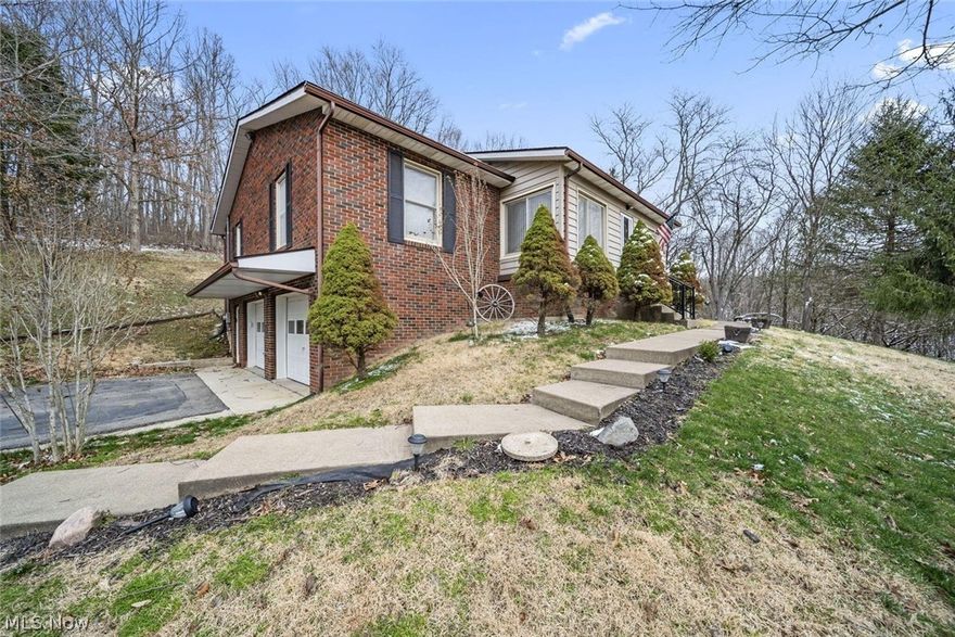 Nestled on 3.36 scenic acres atop a hill in Warsaw, this spacious 3-bedroom, 3 full-bath home offers over 1,674 square feet of comfortable living with beautiful surroundings and room to enjoy the outdoors.

Step inside to find a welcoming layout with generous living spaces and a finished walkout basement featuring a cozy fireplace, creating the perfect spot for relaxing or entertaining. The lower level consists of a large laundry room, full bath, storage room, 200 amp service, hookup for generator, large storage pantry The walkout design provides easy access to the property. 

Enjoy peaceful mornings on the covered front porch and unwind in the evenings on the covered back porch, both ideal for taking in the countryside views. The property also includes 2 outbuildings for additional storage or workspace as well as an extra carport for added parking and convenience.

With acreage, privacy, and versatile living space, this hilltop property offers the perfect blend of country living and functional comfort.  * NOTED TREES ON THE PROPERTY - PawPaw, Walnut, Sycamore and White Oak *