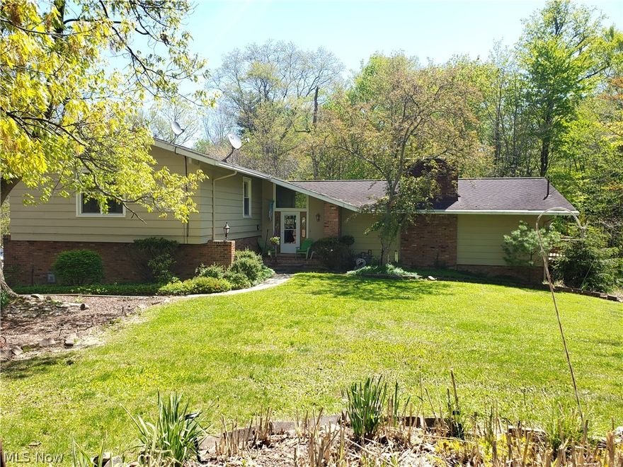 Location is the key to this beautiful Pepper Pike Home on a 1+ Acre wooded lot located on a desirable dead end street. Not your normal 3 level split. Main floor boasts wood floors throughout, wide open eat-in Kitchen that has been updated with Island, Wood Cabinets, Granite Countertops, double ovens, built in pantries & all appliances stay. A spacious Dining Room with wooded view just off the Kitchen. Completing the main level is an Amazing Oversized Great Room with vaulted ceiling, wet bar, custom built in cabinets on both sides of the brick wood burning fireplace (with gas), Large Windows and Sliders that allow an abundance of natural light in and open to the wrap around deck that is perfect for your wildlife viewing, relaxing or entertaining. The top level consists of the Large Owner's Suite, w/vaulted ceilings, two closets and en-suite bathroom w/dual sinks, make-up station, and separate shower and tub. A half bath is also located on this level. Your lower level is a ground level t