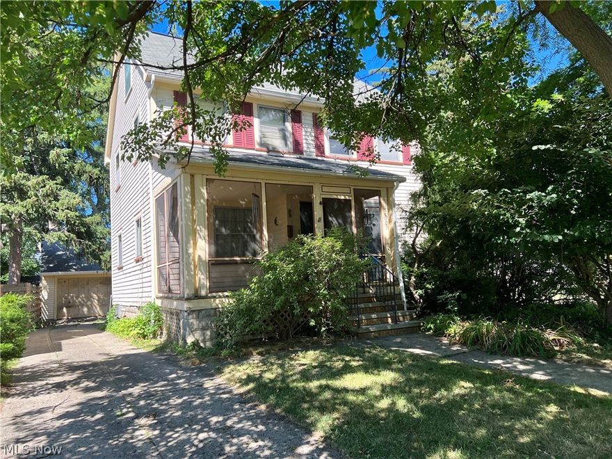 An incredible opportunity in one of Cleveland's coolest and most slept-on neighborhoods. Enjoy Collinwood lake life on a dead end street! This classic, 1920 colonial needs a new owner to give it the love and restoration it needs. She's beautiful but she needs work! This property also includes the parcel next door for a rare, double lot size of 9,200 sq ft in the city. This home includes so many desirable, vintage features such as original hardwood floors, beautiful, leaded glass window in the bathroom, original bathroom floor tile, and formal entryway with coat closet. Spacious first floor has a classic living room with fireplace and formal dining room. Restore the vintage, metal kitchen cabinets or start with your fresh design! This home also features three bedrooms on the second floor, two full bathrooms and a new furnace. Finished third floor could be a primary suite or rec room! This home also has a two-car garage and screened in front porch for those perfect summer evenings! You w