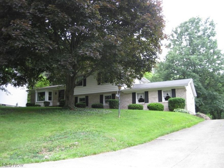 REDUCED! This 4 level split is a one owner home, built by the Amish, and it shows! Replacement tilt in windows through out. Beamed cathedral ceiling. Beautiful hardwood floors. The family room features a wood burning fireplace and built in bookshelves.  The 4th bedroom makes a great den/office. Cement drive leads to rear load 2 car garage.  Plenty of extra parking room too!  Great location and a peaceful park like setting on over an acre.  Fruit trees and small wooded area.  Nice storage shed.  This home is extremely well constructed and appears to be larger than the auditor's sq. footage reflects. Motivated sellers!