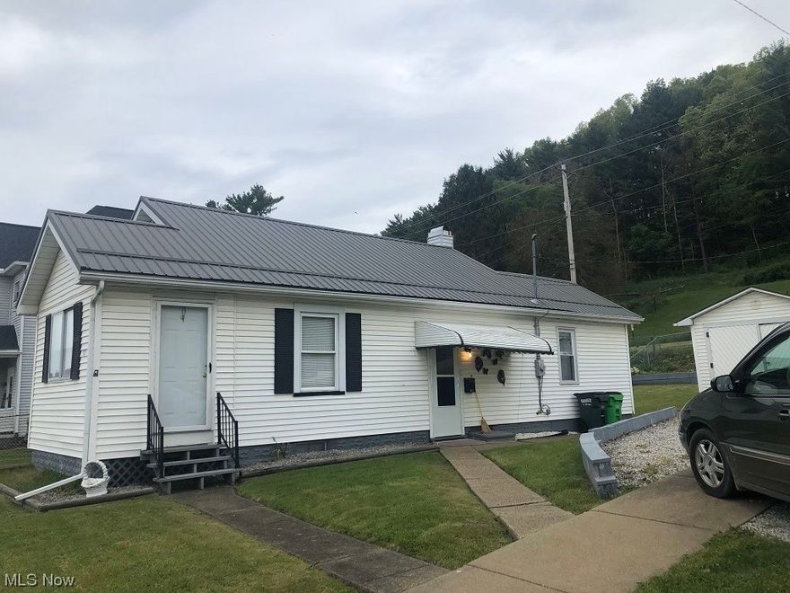 Very well cared for 2 bed 1 bath ranch home on nice corner lot. Eat in kitchen with new laminate flooring and is complete with appliances. The 2 bedrooms offer nice closet space and there is a main floor full bath. The lower level has two nice storage rooms and a crawl space under the kitchen addition. The yard is partially fenced  and offers a nice size outbuilding for your storage needs. The newer rear covered porch is a great place to relax. Recent updates include: Metal roof, rear porch, laminate flooring, all drains and water lines have been replaced. Home has nice curb appeal!