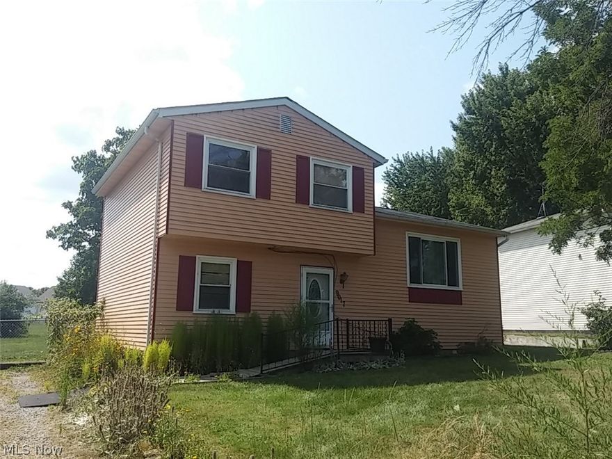 Split level home with kitchen, dining area with knotty pine paneling, living room and full bath on main floor.  3 bedrooms on second floor with family room and laundry room on lower level.