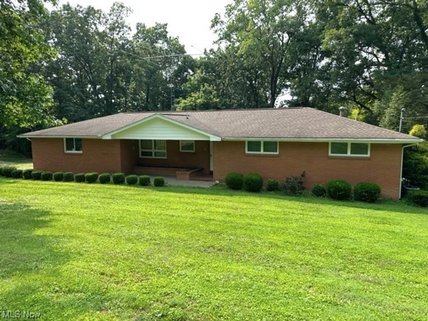 This solid brick ranch in the Maysville SD offers a picturesque lot and very nice outbuilding with electric, water, heat & additional electric panel.  3 spacious bedrooms w/hardwood floors, (owners suite), oak kitchen loaded with cabinet space, 3 full baths (2 on the main level and 1 in the basement), living room w/fireplace and large windows overlooking the scenic wooded area, 2 car attached garage, 4+ acres, charming gazabo to enjoy the beauty of the property, full walk out partially finished basement for additional living area. Newer tankless hot water tank, HVAC System and Roof. Whole house generator.  This home has so much to offer make an appointment to view this home soon.