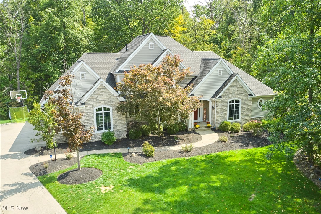 Welcome to this beautiful 4-bedroom, 3.5 bath Colonial located in the highly desirable Deer Creek Reserve of Richfield Township. Built by Prestige Homes, this property blends timeless craftsmanship with thoughtful updates throughout.
At the heart of the home is the chef’s kitchen, complete with a Viking range and hood, granite countertops, and an inviting morning room that opens to a freshly painted multi-tiered deck (2025) overlooking the wooded backyard. The dramatic two-story great room features a stunning stone fireplace and a wall of windows that fill the space with natural light. A private first-floor master suite offers its own fireplace and a relaxing retreat. Formal dining, a dedicated home office, laundry room, and half bath complete the main level.
Upstairs, you’ll find two spacious bedrooms, a loft, and a full bath. The finished lower level with 2300 sq.ft, offers additional living space with a rec room and fireplace, kitchenette, billiards room, 4th bedroom, workout room, and full bath, plus a convenient stairwell leading to the 3-car garage.
Peace of mind comes with recent updates, including a new roof (2025), new HVAC & A/C (2026). Award-winning Revere Schools and an excellent location near Furnace Run Metro Park, Richfield Heritage Preserve, I-77, and the Ohio Turnpike make this a truly special place to call home.