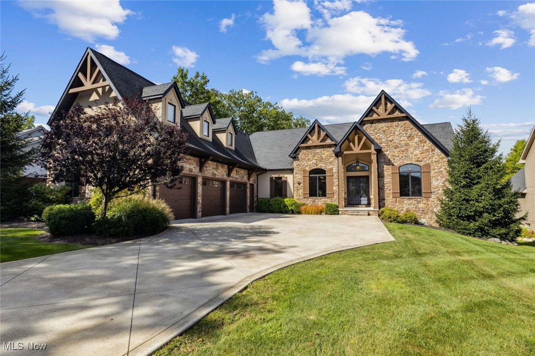 Step into a lifestyle where every day feels like a retreat. This custom newer built & fully updated 6,576 square foot luxury residence is nestled on a park like ~1 acre lot. Inside, soaring 14’ box beam ceilings, 10’ windows, 8’ doors, designer lighting and custom woodworking create a masterpiece of design. The kitchen is a culinary dream with a 10’ granite island, high end appliances, gas range & walk in pantry. The living room features 14’ tall box beam ceilings & 10’ windows. The private outdoor veranda features its own fireplace & commercial built in grill area. For the professional, the large executive office features insulated walls, 15’ vaulted ceilings & 8’ windows. All four king-sized bedrooms have walk-in closets, three are en-suites. The primary bedroom is a private sanctuary of its own, boasting 15’ vaulted ceilings, 10’ windows, an oversized freestanding tub, a 10’ vanity, luxurious shower, and a large walk-in closet. The huge lower level is a true escape, embodying a boutique hotel vibe with an elevated lounge which includes a full bar with a built-in double-tap kegerator & a wine room for private tastings. The theater area features tiered seating and upper-level bar that overlooks the built in 83” TV and fireplace. For wellness & recreation, you'll find a dedicated home gym with infrared sauna. The lower level also includes a second primary-sized wing with a custom-tiled, double-headed shower. A large open area complete with laser lights can be used as a dance floor or is perfect for a pool table & game area. An additional flex bonus room with its own fireplace offers endless possibilities such as a studio, 2nd office, or playroom. The home features a long driveway to its spacious 3 ½ car garage and smart features like voice-controlled lighting, irrigation system, multi-room audio & security system. Centrally located between I-77 & I-71, just 20 minutes from d-town & the airport, and minutes from local wineries, breweries, bike trails & great schools.