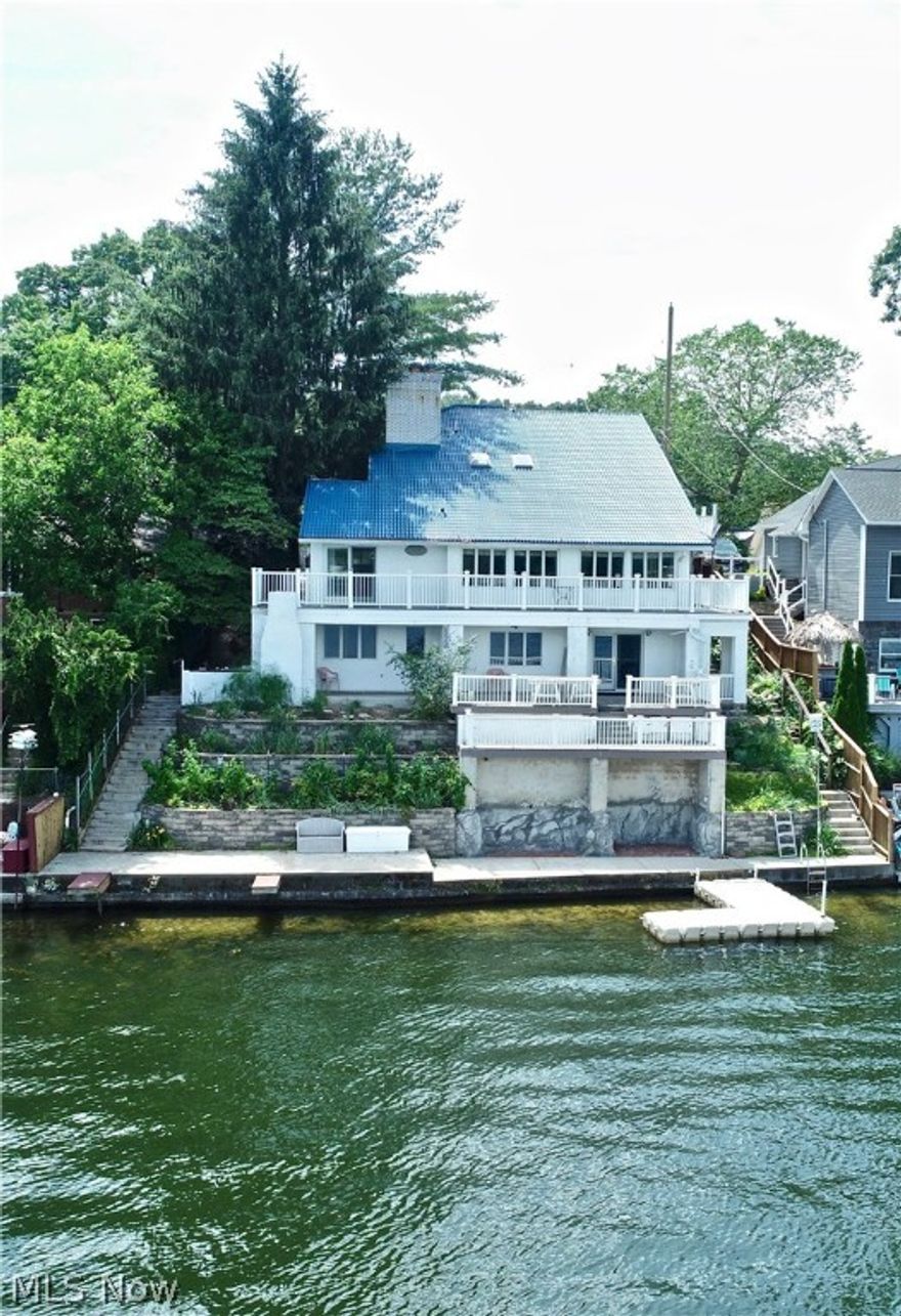 Truly a Rare find!! This Lakefront Classical Contemporary offers a Guest Rental and or in-law suite. 3 Kitchen 4 full Bath rooms!  Million plus $1.00 Dollar views on Main Chain East Reservoir  of the connecting Portage lakes. On city sewer.  Square footage above included walk-out lower level. Attach in law rental has separate gas and electric. Metal 50 year roof 2015, 2 furnaces and 1 of the 2 central airs 2004, new sea wall 2015, Hardwood floors added 2010, Newer electric wiring and Plumbing.Over 70 foot of lake frontage with multiple boat docking. Perfect for year round home or summer get away with year round income!