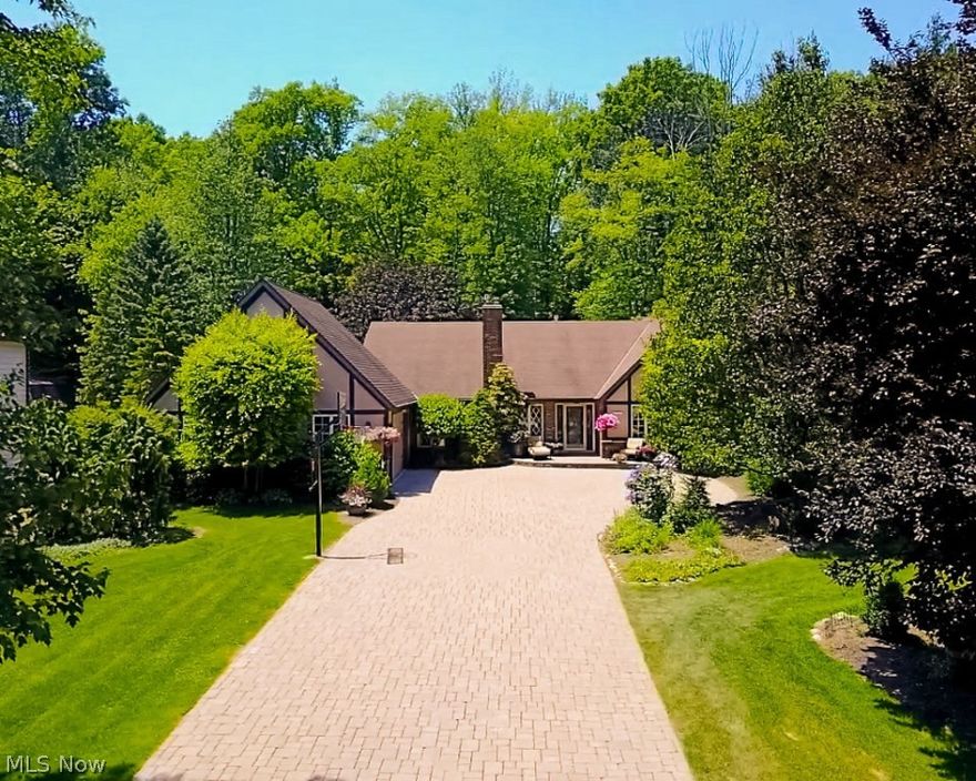 Beloved family home on over an acre of gorgeously landscaped land. Curb appeal abounds beginning with the unique paver drive beckoning you in to this home. Quaint cottage style feel, but a sprawling Cape Cod style home awaits. Front entry foyer w/large closet, side leading staircase and french doors. Expansive formal living/dining room with gas fireplace, vaulted ceiling and crown molding. Cozy family room has second gas fireplace, impressive mantel and patio doors open to the stunning paver patio and yard. Fully fenced, lovely space to relax and entertain with family and friends. Pond, above ground pool, spectacular landscaping, shed and don't miss the hideaway clubhouse just beyond the fence. Huge 4-season room has heated paver flooring. A beautiful indoor/outdoor living space off the Master bedroom. Three bedrooms and 2 full 1 half bath are found on the 1st floor. Two adorable carpeted bedrooms and full ceramic bath on the 2nd floor. This is a character filled home with hardwood flo