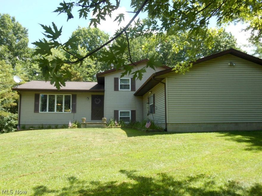 Nestled approx 500 feet back a private drive is a little bit of hidden paradise! Beautiful 4 level split home on over 11 wooded acres with 2 car attached garage, 1 car detached garage, complete with wood burner, and a huge (60x30) OUTBUILDING (with gas hook up)!  Main level of the home features a kitchen (stove, dishwasher, and refrigerator stay), living room, and dining room,  all with vaulted ceilings and beautiful wooded views. On the upper level you will find 3 bedrooms, all with double closets and ceiling fans, and a full bath. (Master bedroom connects to full bath).  The lower level features a spacious family room, 1/2 bath (plumbed for a full bath), wood burning fireplace, and sliding glass doors leading to brick paver patio. Don't forget about the basement! Shelving and cabinets will stay with the house. High efficiency furnace and central air were both replaced within the last 5 years.  Gorgeous property surrounds this home!  Seller has maintained pathways through the  woods f