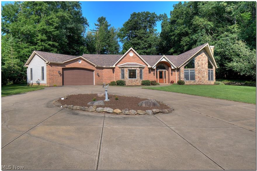 Custom Stone front Ranch with over 3400 square feet on over 2 picturesque acres. Spacious open floor plan with Walnut engineered wood flooring.  You can be one with nature in this priceless retreat set back off the road.  Great room with vaulted ceiling and wood burning fireplace.  Formal living room/parlor, sunny sun room, and formal dining room.  Large eat in kitchen with granite counters, tile backsplash, gas cook top, wall oven, breakfast bar and nook.  Master with 7 x 6 walk in shower surrounded by curved glass block, double sink, whirl pool tub and monster sized walk in closet.  Two additional guest bedrooms with ample closets and adjacent bath.  Special features include 18x16 Storage barn with work bench and electric, ideal for additional car storage or workshop.  Newer roof and gutters 2016, professional landscaping, updated flooring 2015, and fixtures, hot water heater 2018, furnace & air original but serviced annually, zoned heating.   Easy freeway access to downtown Cleve.,