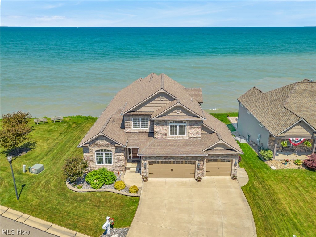 Live your best life in this lake front home located in the gated community of Villa Grande Estates. As you enter the front door, you and your guests will be drawn to the floor-to-ceiling windows that frame the ever changing lakescape. Step outside onto the covered deck which is one of the many perfect spots for relaxation, entertaining, chilling as the seagulls pass by, and taking in a marvel sunset. Watch the sailboats go by from your master bedroom conveniently located on the main floor. The formal dining room is currently being used as an additional first floor media room. The finished lower level is a delightful bonus, featuring a walk-out patio and spa, fireplace, full bathroom, workout area, and a theater room where you can enjoy memorable movie nights with loved ones. The community park, adjacent to the property, offers plenty of recreational space exclusive for members. Additional community amenities including park with walking trails, pavilion, and private staircase leading to