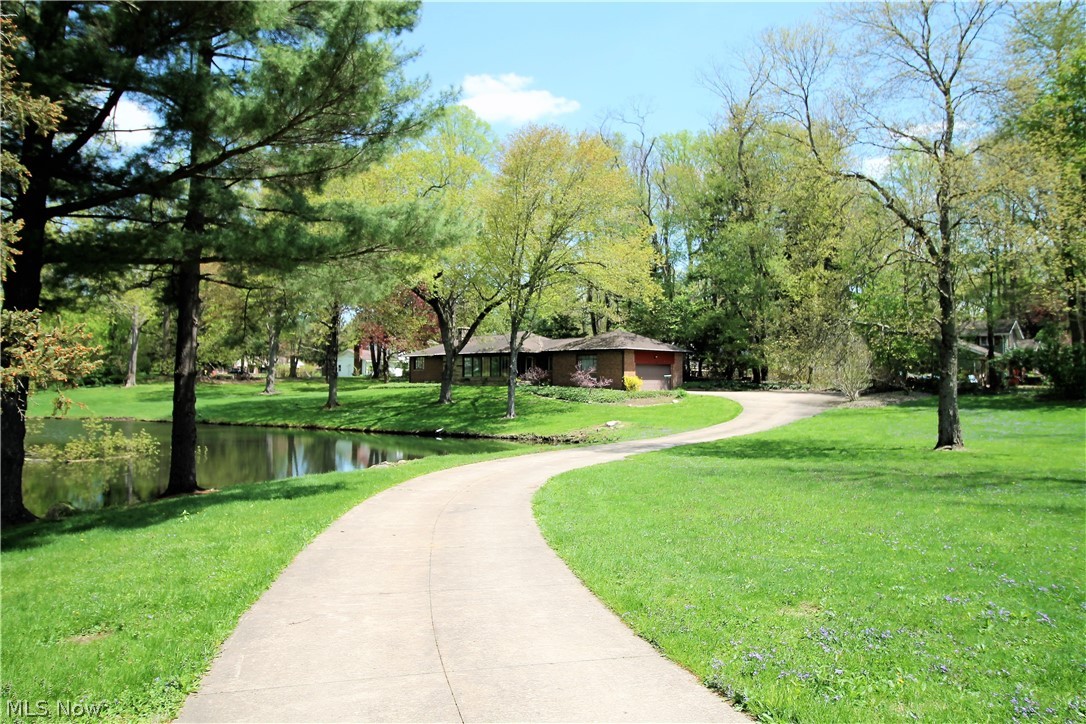 Do you want privacy? Welcome to this charming ranch with winding driveway that sits back from the road and has an astonishing pond to enjoy on over an acre lot. This two bedroom, one and half bath home offers a large bright and airy great room with magnificent large windows to view the sensational pond and also offers wonderful hardwood floors, built in bookshelf and fireplace. The kitchen has eat in area, abundant of cabinets and counter space and offers an extended stainless steel food prep work area and pantry. The dining room is off of the kitchen with hardwood floors and plenty of windows to let in the sunshine. There are two large bedrooms with large closet space, hardwood floors and nice size windows. The huge finished lower level can offer so much more space for an additional family room, recreation room, office space etc there is also an extra shower. There is a two car attached garage with water available. The back porch is a nice area for grilling and there is a shed as wel