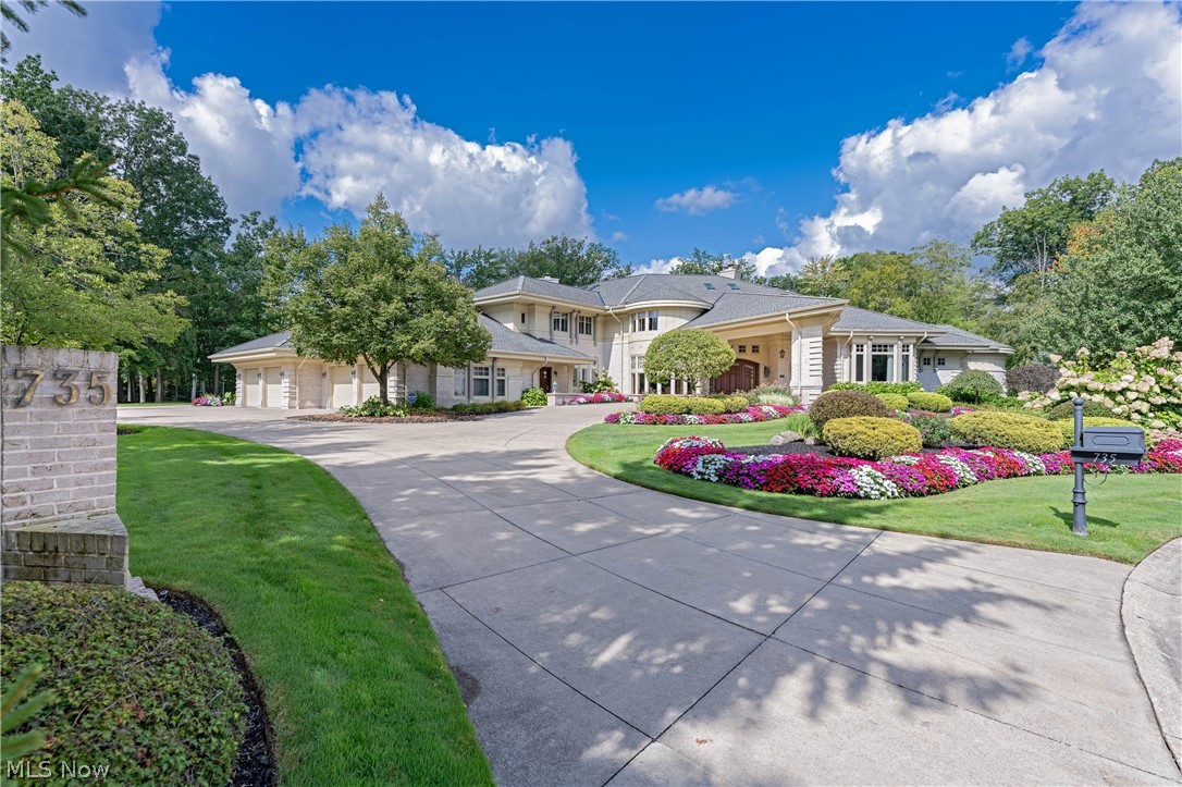 Nestled on 2.6 acres between the 13th and 14th fairways of Barrington, sits one of the most spectacular properties ever offered within this gated community. From the multiple sandstone patios to the soaring ceiling heights, to the resort-style indoor spa and pool, to the magnificent finishes throughout; it is without equal anywhere on the market. Elegant entry doors open to the grand foyer that flows into the formal dining and living rooms. The stunning great room boasting soaring 25 foot ceilings, a wet bar, and towering walls of windows flanking an enormous fireplace. The great room is open to a secondary dining room and chef’s kitchen complete with top-of-the-line appliances. The primary suite includes a stunning office, walk-in closet, luxurious ensuite bath, and a spacious bedroom with separate sitting room, fireplace and private access to the spa. The spectacular indoor pool and spa is an amenity unto itself, with access to the Florida room, patio, sun deck, changing rooms with full baths, saltwater pool with waterfall feature, whirlpool spa, steam room, sauna and more. Upstairs, there are 3 large bedrooms, all with ensuite full baths including one bedroom with its own kitchenette and private entry. The expansive lower entertaining level features a wine cellar, large bar, home theater, tasting room, and family room with a beautiful ornate double fireplace open to the theater. This property is one-of-a-kind and offers an incredible lifestyle unmatched in Northeast Ohio.