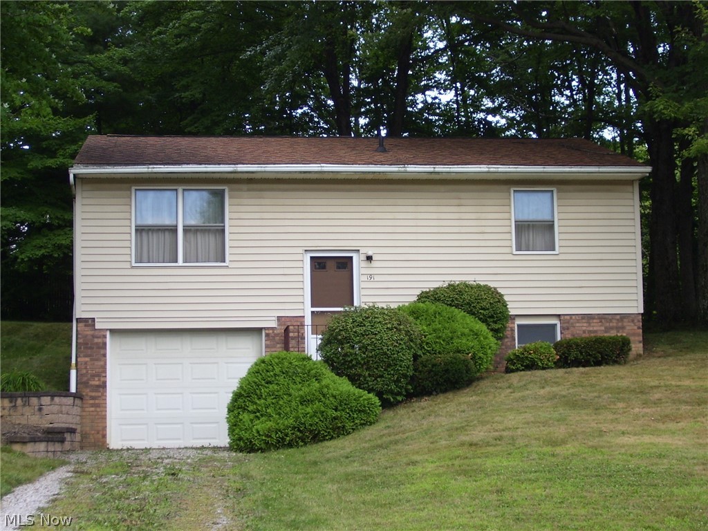 Large kitchen with carpeted dining room area for nice sized table and an exterior door to rear yard. Spring, summer and fall will give you time to relax on the rear patio while enjoying the view of the woods. Many possibilities for the lower walk out level. Currently being used for excercise equipment and an unfinished rec area.