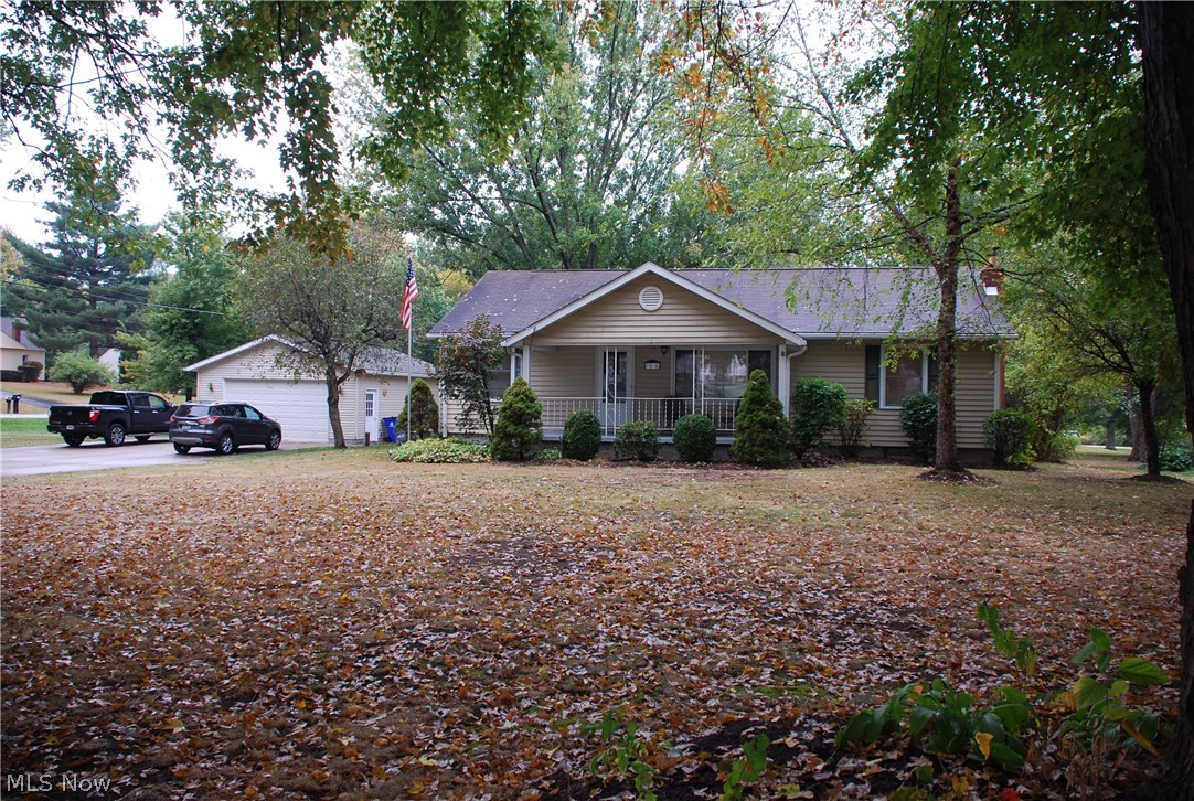 Awesome Ranch home, raised in the back w/ Day-lighted windows in the newer basement level. 3 bedrooms, 2 full bathrooms & large detached garage. Huge master bedroom suite addition 2004 is 30' x 22' w/ vaulted ceiling, glass door large walk-in closet w/ plenty of built-in shelving, huge tiled bathroom w/ separate jetted tub & double seat shower. Hardwood flooring throughout all living spaces w/ tile in the bathrooms & kitchen w/ awesome lighting updated throughout. Dining area addition w/ open concept to well thoughtout kitchen w/ 2 pantries open to a large Living Room. Garage has 2 car wide garage door w/ an oversized space both in width & depth 24'x31' built 1993 has plenty of room for extra fun vehicles w/ workshop & storage above! Property is over an acre for your pleasure w/ fire pit surrounded by privacy landscaping, fruit trees w/ great eating apples, front open porch to sit on as well as rear enclosed sunroom which looks over a gorgeous rear patio w/ benches that is great for en