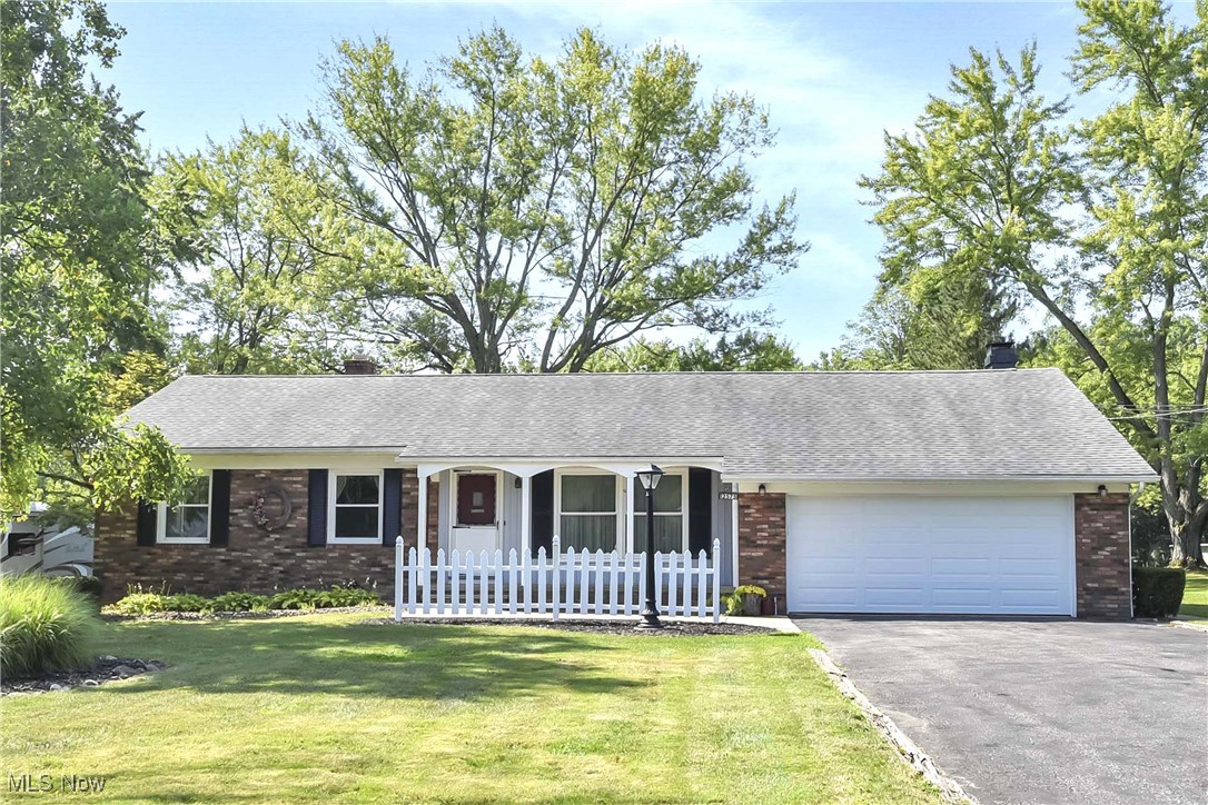 Welcome to this well cared for 3 bedroom, 1.5 ranch home set on a private .75 acre lot. Inviting wood floors extend throughout the living and dining room. Living room has a large picture window overlooking the front yard. The kitchen features new LVT flooring and includes all appliances, with a convenient half bath just off the kitchen. The family room offers a wood-burning fireplace and sliding glass door that leads to a covered deck ideal for entertaining. All three bedrooms have wood flooring and share a full first floor bath. The full basement includes a laundry room and a partially finished recreation room ready for flexible use. Outside you'll find a spacious, private yard and an outbuilding perfect for a workshop. Pride in ownership shows throughout. Move-in ready. Schedule your showing so you can enjoy the upcoming CLE fall in the charming home.