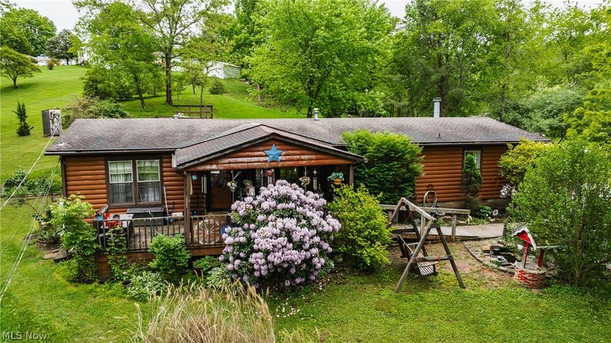 Welcome to this ONE-owner 2002 Double-wide home.  You will find a nice-sized Living Room and semi-open floor plan for the Den, Dining, and Kitchen areas. New LVT flooring has been installed in most of the home. (The carpet in the Master and Master bath are original to the home. Needs replaced)  The laundry is just off the kitchen area.  There is an extra storage area 6x5 with shelving for those extra supplies, etc. You will find two nice storage buildings that will convey to the property as well.  A KOI pond is located as
you walk up to the front porch area and some landscaping is in place. The home sits on the bank and gives you a semi-private feeling
looking at other properties located below.  The driveway is blacktopped and a nice size at the top for parking 2-3 vehicles with ease. There are two parcels with this property.  Looking for outside of town and less of the hectic noise of the city.  This could be
the one for you.