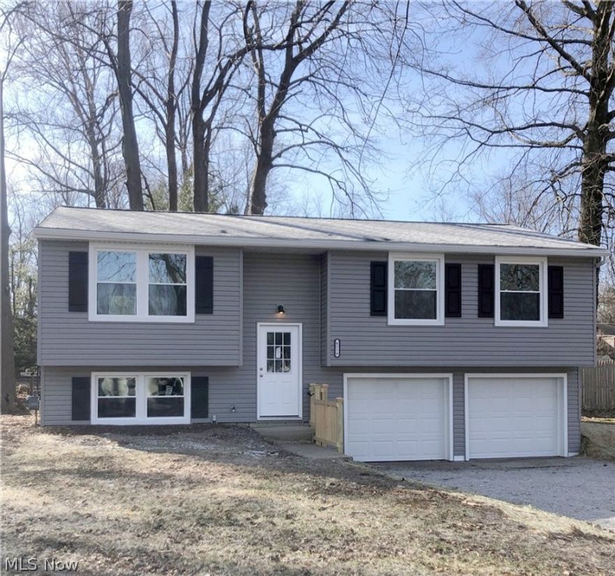 Fantastic renovated home that was brought down to the studs and now look at this beauty. Pretty much everything is newer. Vinyl siding, roof, shutters, deck top, driveway drain. Wait until you walk in and see all that this home offers...luxury vinyl flooring, carpet, soft-close cabinets, granite countertops, vanities, plumbing, electrical outlets, LED lighting, closet doors, blown in installation in attic, windows, doors, furnace, A/C, tankless water tank.  The kitchen is an open floor plan and has an island between the kitchen, living room and dining room with slider to the newer deck surface. Stainless steel stove, dishwasher and microwave included. The bedrooms offer nice size closets and all newer bathrooms too!  The lower level has access to the two car garage, large closet, one of the full baths and separate utility room. You will fall in love!