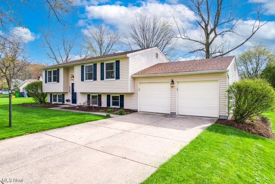 This exceptional 4 bedroom, 1.5 bath bi-level home has been completely updated with no detail overlooked. The living room is adorned with luxury vinyl floors and an elegant electric fireplace (2022). A full kitchen remodel (2019) features newer floors and countertops, stainless appliances, and custom cabinetry, creating the perfect space for gourmet meals. The fully enclosed porch overlooks the large and private backyard complete with deck and offers a serene space that can be enjoyed year round. In 2021, the upstairs bathroom was completely remodeled, featuring the latest bathroom design. Downstairs, is a cozy family room with an attached half bath, perfect for entertaining guests. The extra bedroom on this level offers flexibility, making it an ideal space for a home office or guest room. In addition, the home boasts a large mudroom/laundry room, ideal for muddy shoes and pet clean-up, with direct access to the 2-car garage. Additional updates include roof (2015), French drains and f