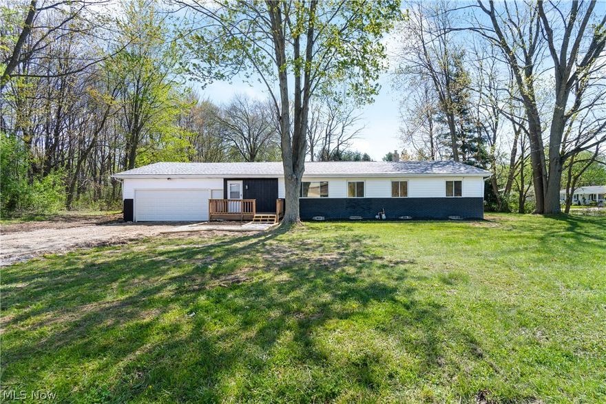 Seeking one-story living in charming Copley Township? This fully renovated ranch delivers! 3 bedrooms, 2 baths in Copley-Fairlawn City School District, situated on a half-acre corner lot. You’re welcomed by a generous front entry with a full closet, offering room to stay organized from the moment you walk in. The living room flows into a beautifully designed open-concept kitchen featuring white shaker upper and blonde wood lower cabinets, quartz countertops with backsplash, Moen fixtures, a large walk-in pantry, new disposal and a brand new stainless appliance package from Whirlpool. The primary suite includes a private en suite bath with a low-curb step-in shower, quartz vanity and sleek black hardware. First floor laundry room with expansion potential for an appliance garage, secondary prep area, or garage-adjacent mud room. Two additional bedrooms plus a fully remodeled hall bath with tub and grout-free surround round out the low-maintenance floor plan nicely. New bright LVP flooring, fresh paint, new furnace, updated electrical, new garage door and opener on the attached extra-deep 2-car garage, and fresh landscaping. Full basement with waterproofing, clean and ready for storage or utility use. Well and septic, septic pumped April 2025. Schedule your showing, there’s nothing left to do but move in.