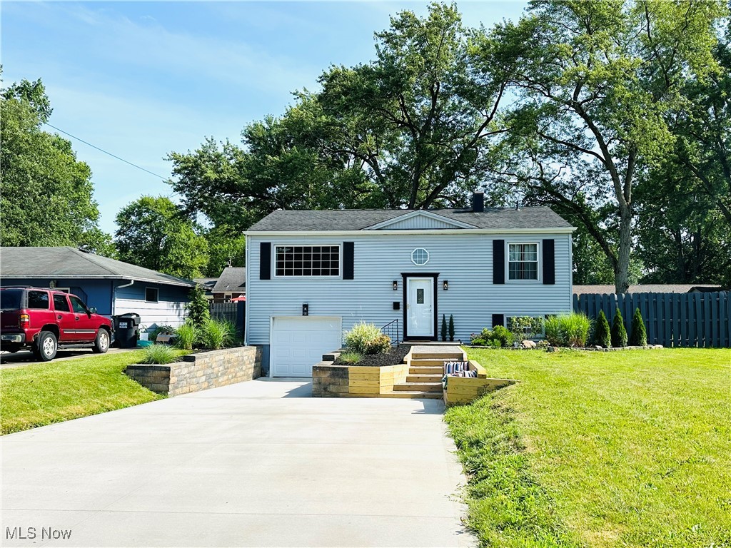 Wait until you see this completely remodeled Austintown 4 bed/2 full bath Bi-level that will NOT disappoint! You have to get here to see all of the sellers hard work that has been done to this HGTV home! As soon as you pull in your brand new concrete driveway with a newly installed drain, you will absolutely love your built-in paver sidewalk, wood bench, and custom steps leading up to your freshly landscaped yard and your inviting front door! Your backyard is completely fenced in and is perfect for your kiddos or pets to run and play for days to their hearts content! You have 2 mature trees in the backyard & a huge outdoor covered patio that is lined w/camping lights & is perfect for your summer birthday parties, barbecues, or family reunions! Bonus: Your lot is extra wide which makes your backyard oasis even better with tons of extra yard space & no neighbor to the right of you which is a very rare find in Austintown! The second you walk inside your new house it "POPS" w/modern upgrades including your super cool entry chandelier light, wood steps with custom trim, & new can lights! Your lower level master bedroom is huge & fits the largest of king size beds, has newly installed tile & has a sweet oversized master bath w/a new vanity, light fixtures, & shower area that has tiled custom shampoo & soap shelving w/a new modern black showerhead & faucet! Mom will love her custom kitchen w/butcher block countertops, a modern backsplash & all stainless appliances that come with your amazing home! Your oversized living room will fit even the largest of sectionals & has newly installed can lights! Your air conditioning is cranking cold which is desperately needed for these HOT Ohio Summers! Your upper 3 bedrooms have brand new carpeting & light fixtures & there has been brand new tile laid throughout the home w/new carpeting giving you that new carpet smell. Fresh paint throughout w/modern colors that today's modern buyers want & need! Better book your showing TODAY!