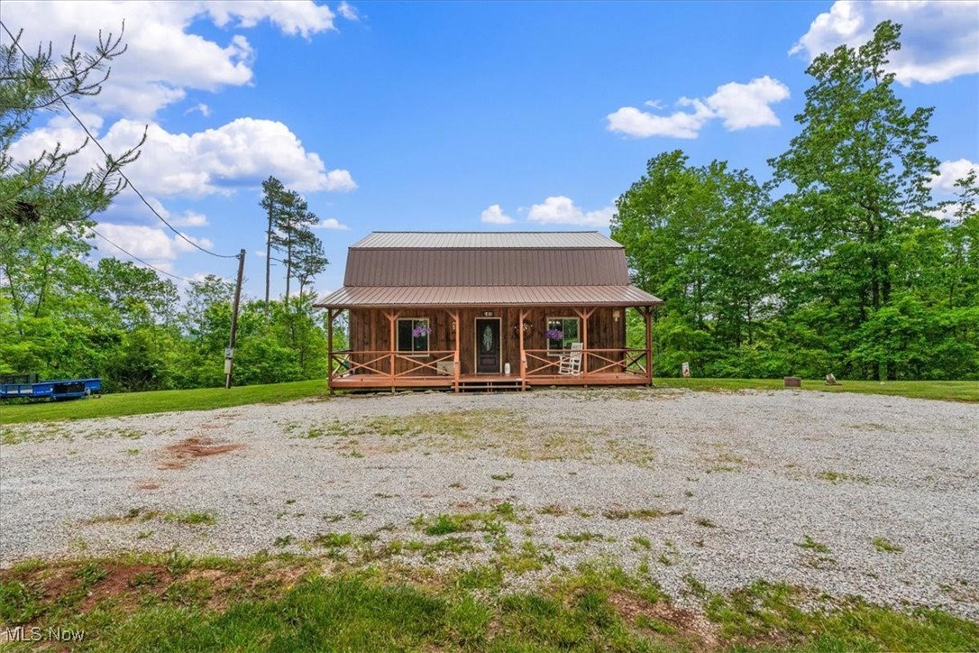 Tucked away in the hills of Wirt County, this 3 bedroom, 2 bathroom cabin awaits! On nearly 27 acres, it is the perfect blend of modern living and country serenity. Step onto the covered front porch and take in the quiet surroundings, or relax out back on the spacious covered deck overlooking your expansive acreage. The inside features a comfortable open concept with the large living, dining, and kitchen areas flowing together. The warm wood finishes throughout provide that rustic charm you're looking for! Don't miss your chance to own this slice of WV paradise, schedule your private showing today!
