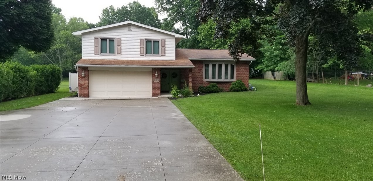 Secluded 3 Level Split home on private street with in-ground pool and large wooded lot of almost 1 acre! This great home offers 5 bedrooms and 2 full baths! Great room and Living room each have fireplace! Lower level features full bath! Garage is Heated and Air Conditioned! Outdoor living includes private vinyl fenced in area with large in-ground pool and 2 large sheds. Large outdoor covered patio attached to home! The kitchen features appliances, pantry and a nice size eating area. Laundry room on lower level. Invisible fence with collar and security system stay with home.