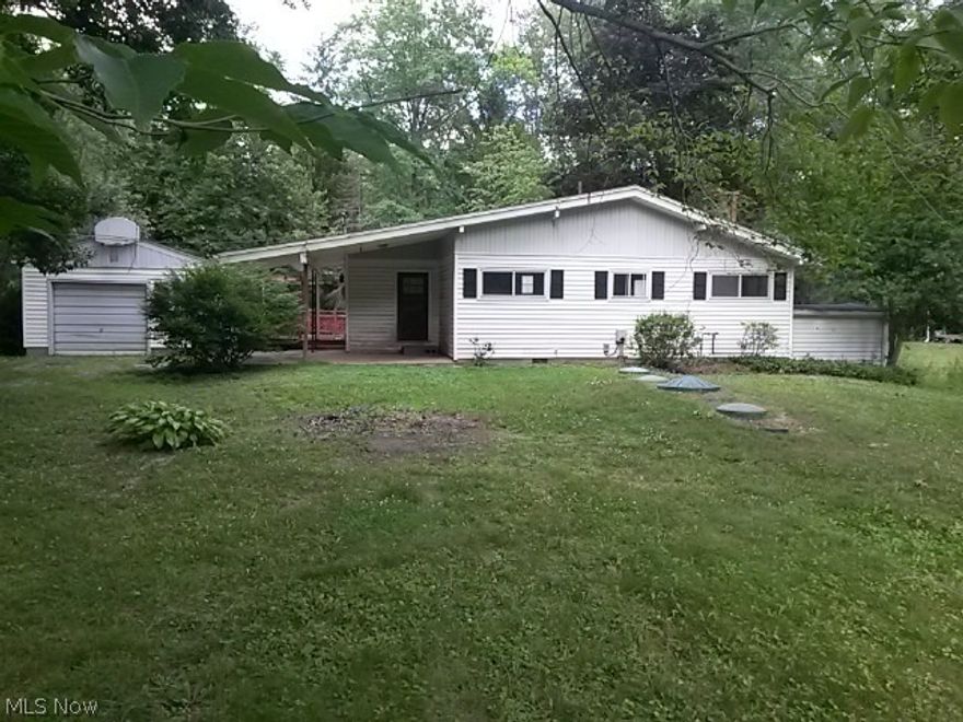 This two bedroom ranch offers large living room with fireplace, eat in kitchen and large sun room over looking the stream.  Scenic back yard with boat dock, and bridge leading to secluded area.  large deck, garage with work shop.  Water fee is $25 per month, Road maintenance fee is $55 per year.  There is a $100 optional fee for lake privileges.