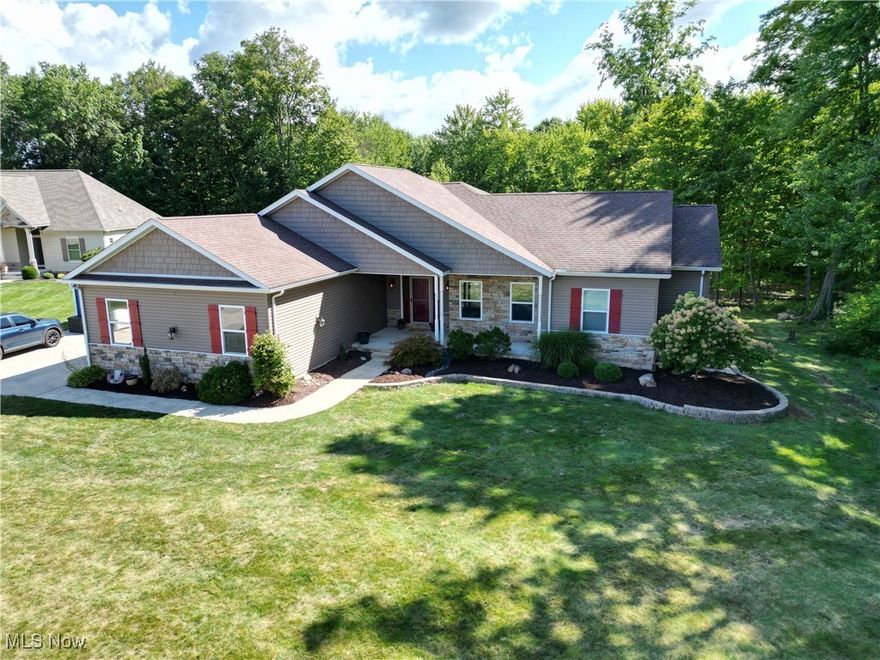 Welcome to your private retreat in the heart of Westfield Center—where elegant design meets effortless living.
This custom-built residence showcases more than 2,600 square feet on the main level and an additional 1,400+ square feet of beautifully finished lower-level living, creating the ultimate backdrop for both everyday comfort and unforgettable entertaining.

Step inside to an airy, light-filled open floor plan that seamlessly blends a chef’s kitchen, inviting family room, and dining space with serene wooded views. The kitchen is a showstopper, featuring a dramatic oversized island, granite countertops, stunning tile backsplash, premium stainless steel appliances, and a double convection oven designed for those who love to cook and host.

The family and dining areas are framed by large windows, drawing in natural light and connecting the indoors with the beauty of the surrounding landscape. Downstairs, the finished lower level expands your lifestyle possibilities with over 1,400 square feet of flexible space—perfect for a recreation room, home theater, gym, or private guest suite.

Step outside to your own backyard oasis: a multi-level Trex deck ideal for entertaining, morning coffee, or sunset cocktails. The hot tub offers a peaceful escape, all set against a tranquil, tree-lined backdrop that ensures privacy and calm.

Every detail of this home has been thoughtfully curated to deliver style, function, and a resort-like sense of relaxation—in one of the area’s most desirable communities. Whole house generator.